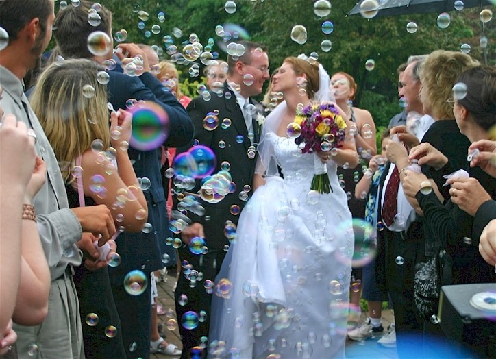 Couple walking among friends and bubbles