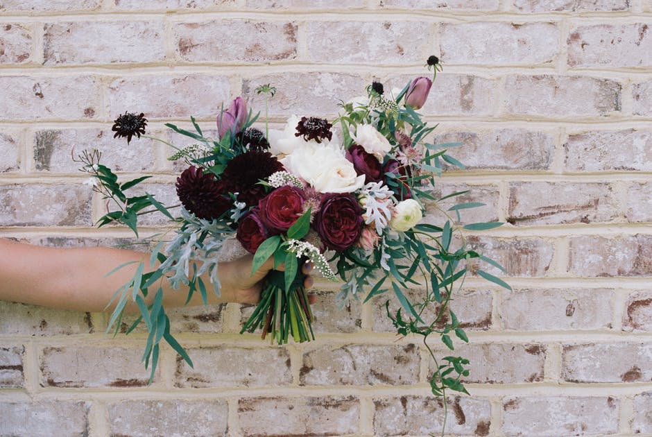 mix bouquet of white and dark red and pink flowers